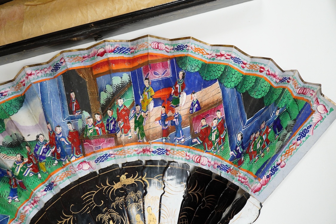 Four 19th century Chinese gilt-decorated black lacquer fans with figure painted leaves, two cased, largest 41cm